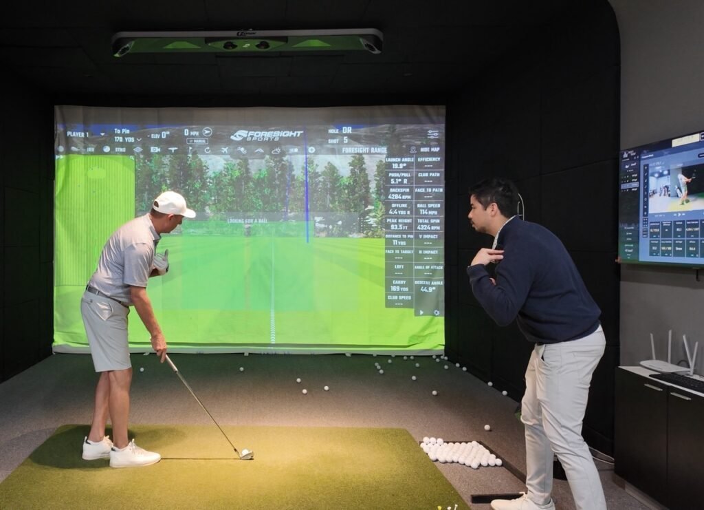 PGA golf instructor Coach Nondh helping a student improve golf swing